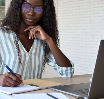 woman writing in a note book