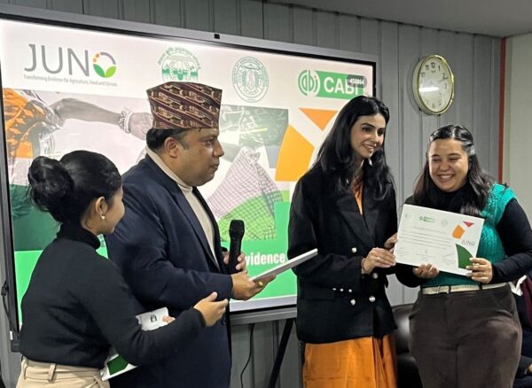Anugya Bhattarai (right) receives a certificate from Dr Umesh Kumar Acharya (centre left), General Secretary, Society of Agricultural Scientists Nepal and Kritika Khanna, CABI (centre right). 
